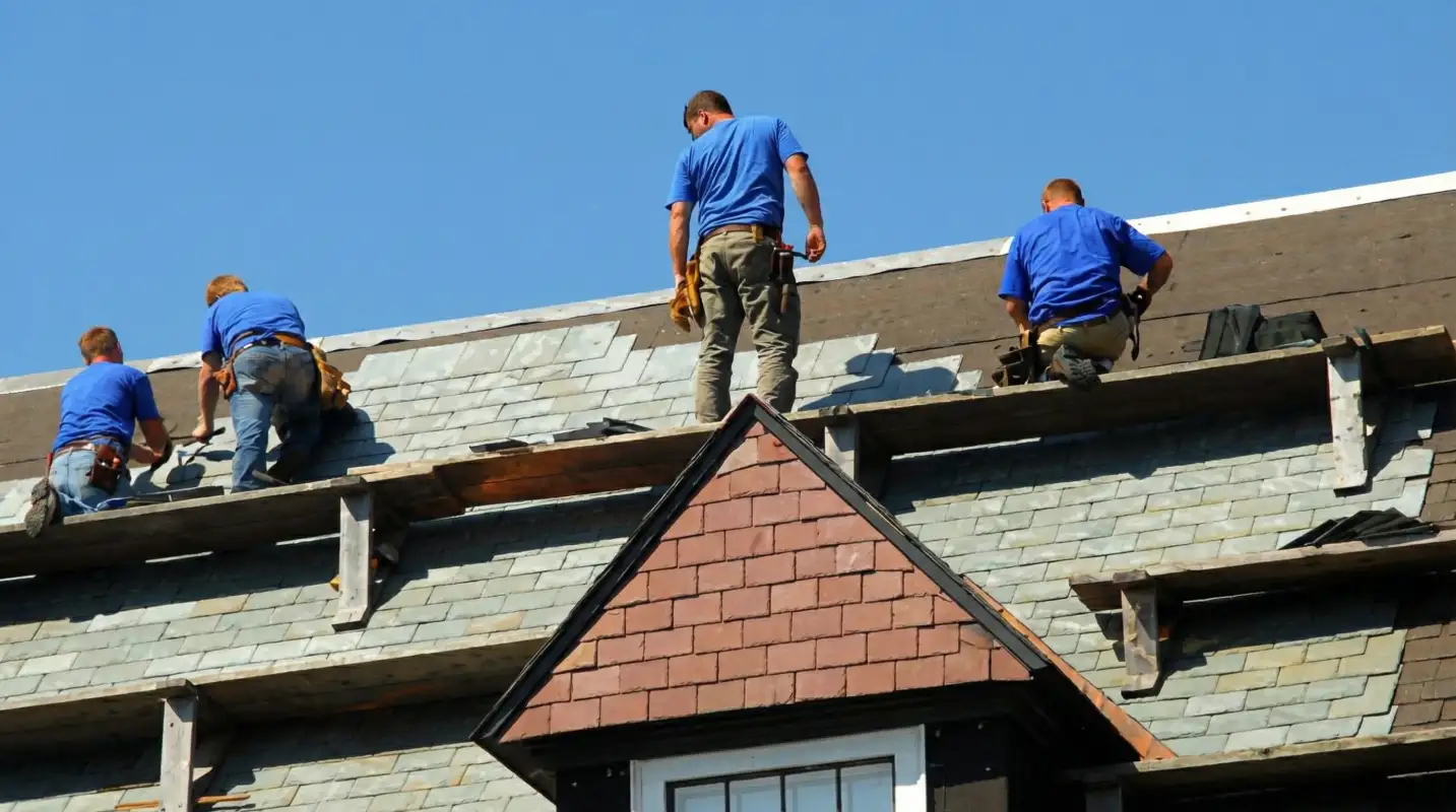Roof replacement in progress with a team of professional contractors installing new shingles on a residential home in Pittsburgh, PA