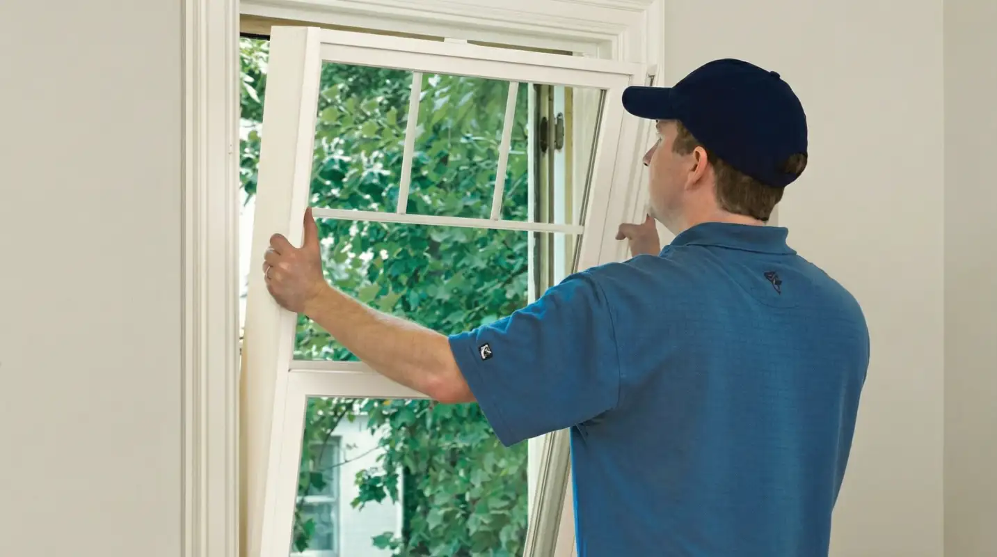 Professional contractors performing a residential window insulation and replacement service in Pittsburgh, PA